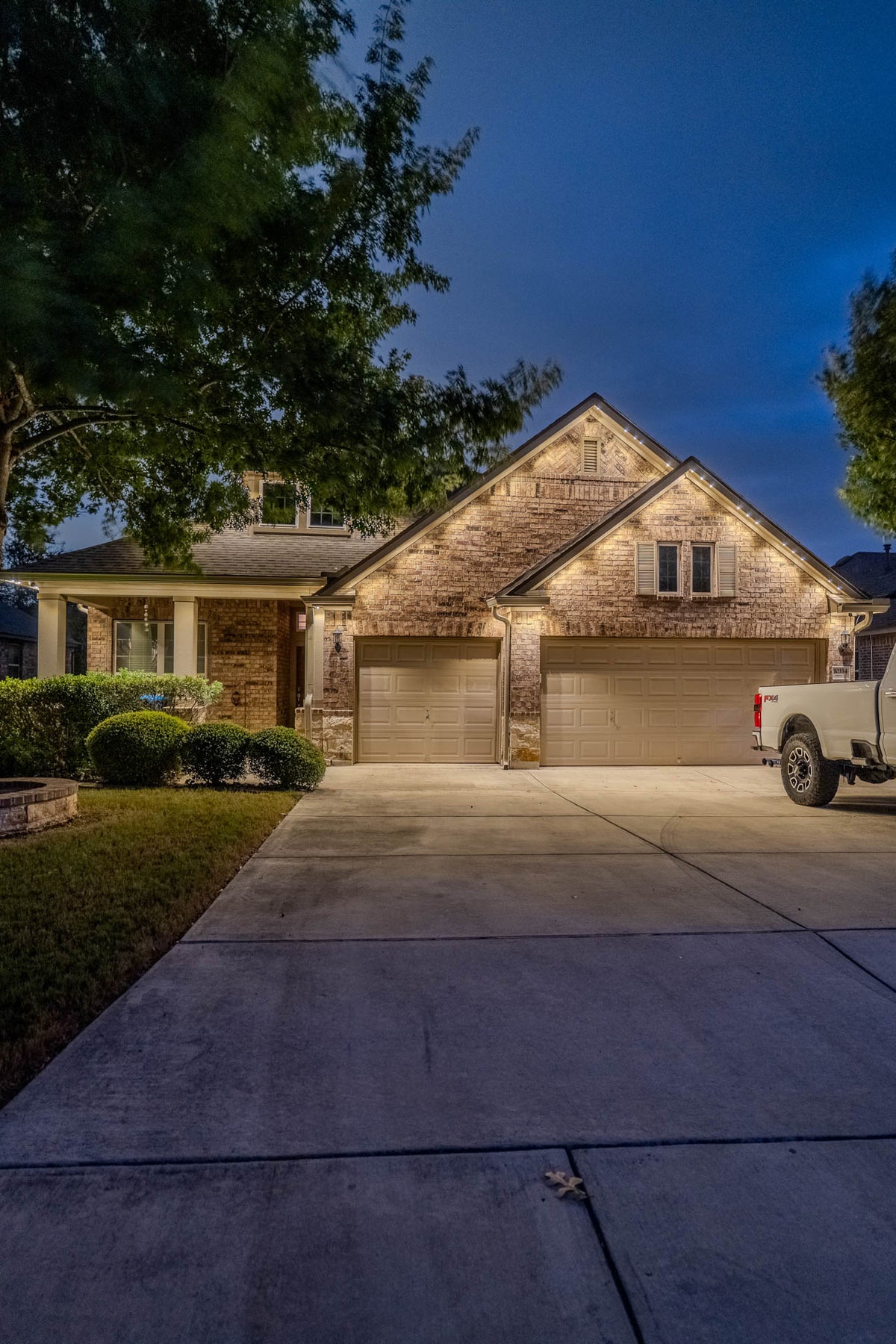 Permanent roofline lighting creating a welcoming evening atmosphere