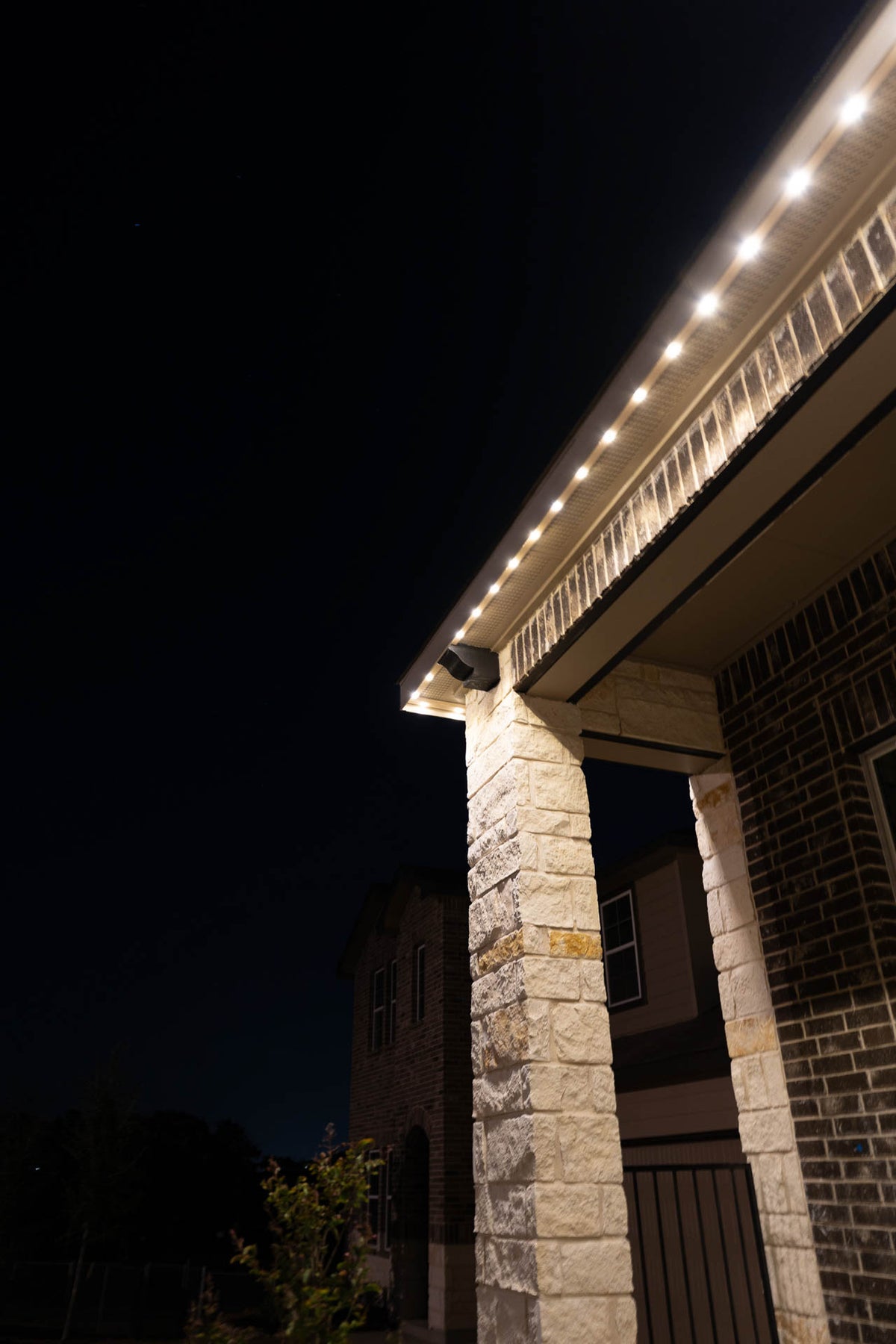 Detail of discreet lighting installed beneath a residential eave