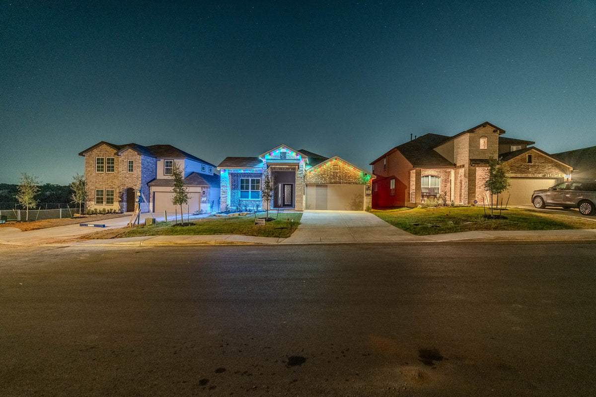 A home illuminated with a multicolor permanent lighting scene