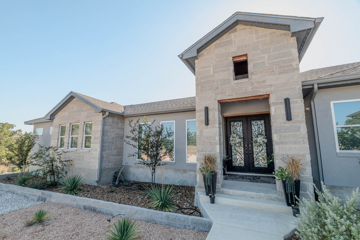 A residential entry with concealed permanent lighting in daylight